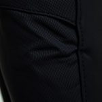 Close-up of linen fabric texture and stitching on black flared leggings with side pockets, showcasing quality and detail.