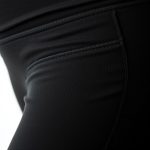 Close-up of soft cashmere blend fabric in black high waisted leggings with pockets, maternity flared design, showing texture and stitching.