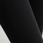 Close-up of black wide leg yoga pants showing fabric texture, stitching, and subtle scrunch detail for quality.