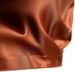 Close-up of the chocolate crop top by Laguna Clothing, showing its silk blend fabric texture and quality stitching.
