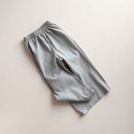 Heather Grey cotton yoga pants with a wide leg, neatly folded in a minimalist flat lay.