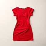 Flat lay of the red First Muse Dress | Shoulder Yoga folded neatly on a clean surface.