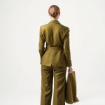 Back view of a model wearing the Olive Green flare pants set raspberry tea leaves on a white background.