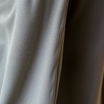 Close-up of the recycled fabric texture and stitching on our conscious clothing flared pants outfit.