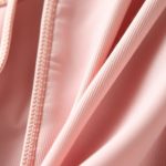 Close-up of the soft, organic cotton fabric and stitching on pink yoga pants.