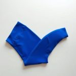 Royal Blue running tights with pockets, leggings with phone pocket, neatly folded on a neutral surface, top-down view.